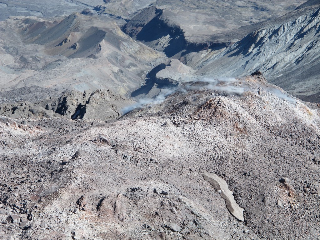 The magma dome in the crater is growing. The steam is evidence of active volcanism.