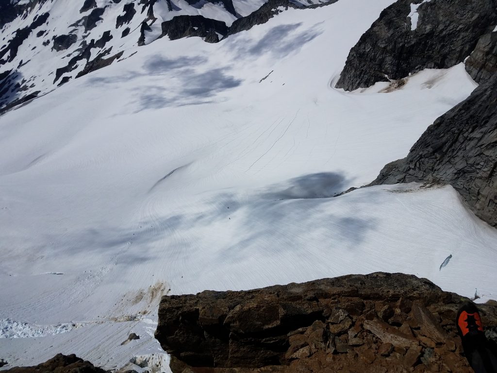 View from the "Sidewalk" of Dome Peak, with climbers on the Dome Glacier.